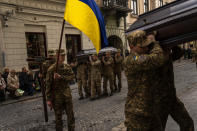 Soldiers carry the coffins of two Ukrainian army sergeants Tomkevych Mykhailo and Kril Olexander during their funeral at the Saints Peter and Paul church in Lviv, Ukraine, Tuesday, April 16, 2024. (AP Photo/Francisco Seco)