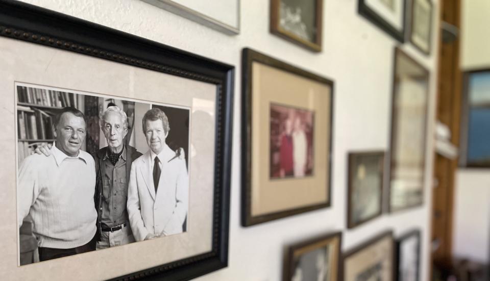 The framed photos in Jim Mahoney's house include an image of Frank Sinatra and Mahoney posing with famed artist Norman Rockwell (center) after Mahoney arranged for Rockwell to paint Sinatra's portrait.