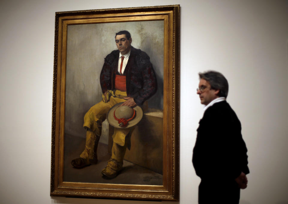 This Feb. 8, 2013 photo shows a security guard walking by Diego Rivera's 1909 "The Bullfighter", part of the exhibition, "Frida & Diego: Passion Politics and Painting," featuring the works of Rivera and Frida Kahlo at the High Museum in Atlanta. The exhibit features more than 140 works, making it the largest exhibition of the couple's art ever displayed together. It includes more than a quarter of Kahlo's entire body of work. Atlanta’s High will be the only U.S. venue for the exhibition, which opens Feb. 14 and runs through May 12. (AP Photo/David Goldman)