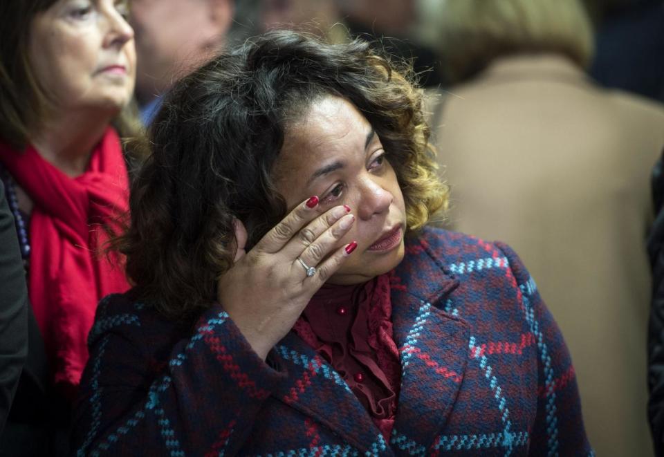 A woman wipes away a tear during the memorial service (PA)