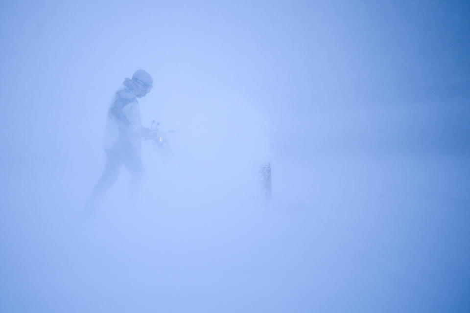 Tim Keefe uses a snow blower to clear his driveway during a snow storm, Wednesday, Dec. 23, 2020 in Robbinsdale, Minn. (Aaron Lavinsky/Star Tribune via AP)