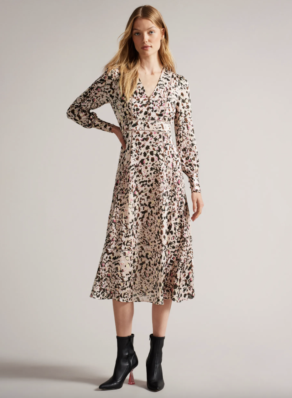 blonde model wearing heeled black boots and long sleeve floral Luceeya Fit And Flare Midi Dress With Ladder Insert (photo via Ted Baker)