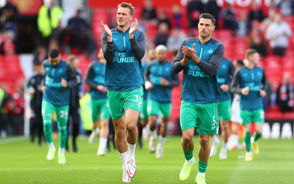 Newcastle United's Dan Burn and Fabian Schar warming up - REUTERS