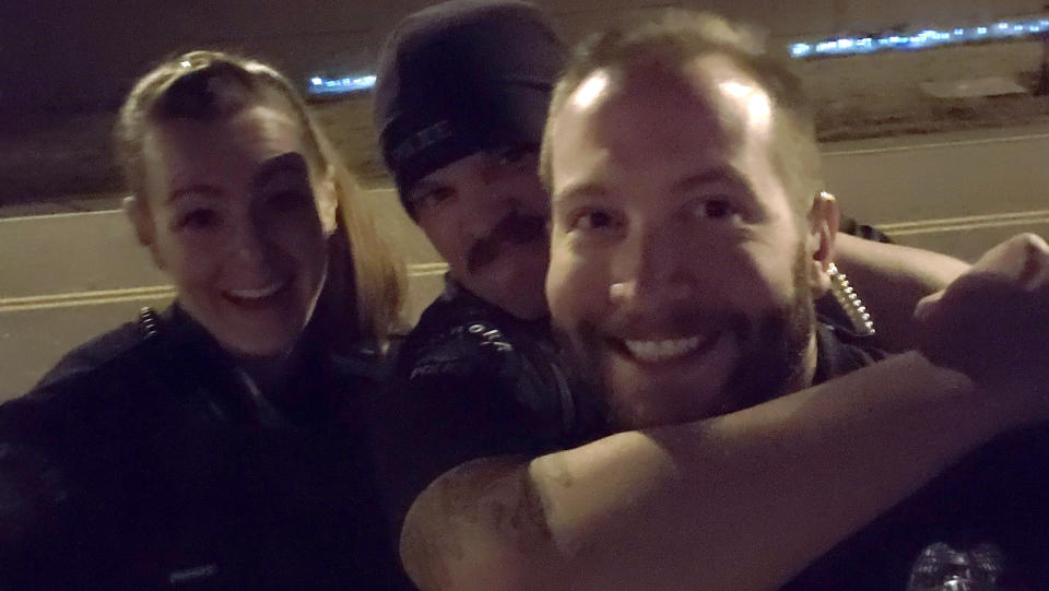 This photo released by the Aurora Police Department, in Colorado, shows Officers Erica Marrero, from left, Jaron Jones and Kyle Dittrich. Jason Rosenblatt, one of three white officers who stopped Elijah McClain, has been fired over the photos showing colleagues reenacting the chokehold used before the Black man died in August 2019, according to documents from prosecutors. The officers shown in the photo have either been fired or have resigned, according to officials. (Aurora Police Department via AP)