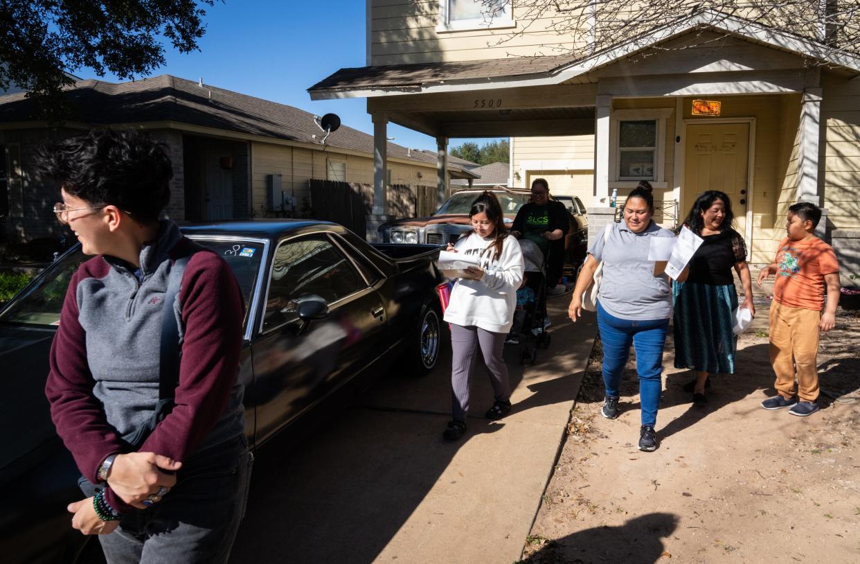 Volunteers and organizers, including Miriam Dorantes, a constituent liaison for Council Member Fuentes, left, Go Austin/Vamos Austin Food Justice Organizer Erica Reyes, third from right, and steering committee member Nolvia Castillo, second from right, knock on doors in Del Valle to gauge interest and gather opinions on bringing a city-sponsored food co-op to the low-income neighborhood that lacks a nearby grocery store, Saturday, Feb. 24, 2024.