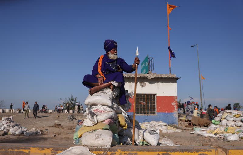 A nihang or Sikh warrior sits on makeshift bunker at a protest site where farmers are marching towards New Delhi to press for the better crop prices promised to them in 2021, at Shambhu Barrier