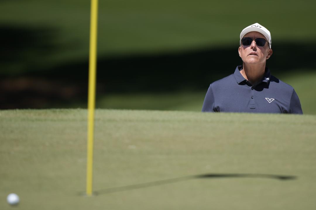 Phil Mickelson watches his shot in his bunker on the seventh hole during the third round of the Masters golf tournament at Augusta National Golf Club, Saturday, April 13, 2024, in Augusta, Ga. (AP Photo/Charlie Riedel)