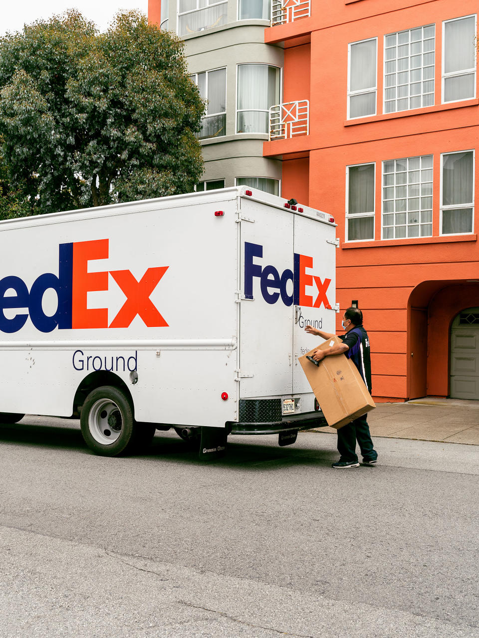 A box containing Jani the giraffe arrives via FedEx to a residence in San Francisco.<span class="copyright">Kelsey McClellan for TIME</span>