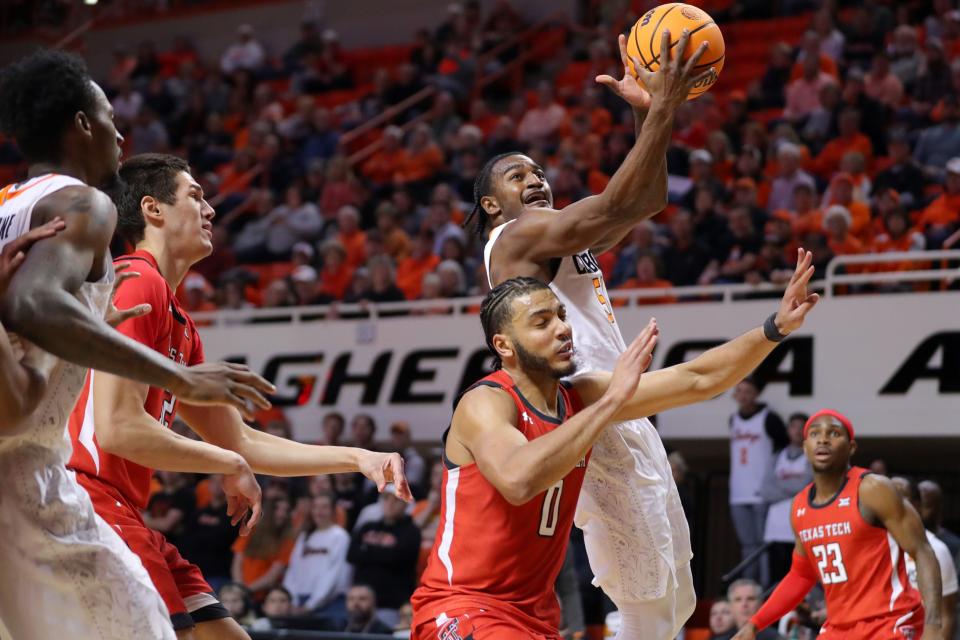 Oklahoma State Cowboys guard John-Michael Wright (51) puts up a shot over Texas Tech Red Raiders forward Kevin Obanor (0) during a men's college basketball game between the Oklahoma State University Cowboys (OSU) and the Texas Tech Red Raiders at Gallagher-Iba Arena in Stillwater, Okla., Wednesday, Feb. 8, 2023. Oklahoma State won 71-68. 