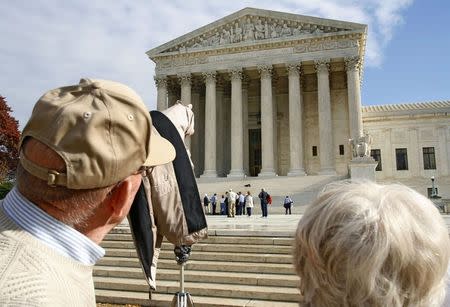 A tourist points at the facade of the Supreme Court building in Washington in this November 28, 2005 file photo. REUTERS/Joshua Roberts