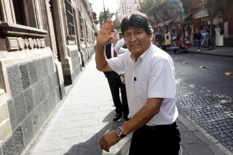 Bolivia's ousted president Evo Morales waves as he arrives to deliver a news conference in downtown Mexico City