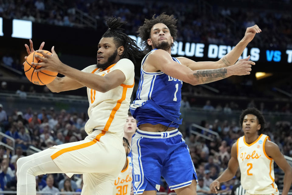 Tennessee forward Jonas Aidoo (0) takes a rebound away from Duke center Dereck Lively II (1) during the first half of a second-round college basketball game in the NCAA Tournament Saturday, March 18, 2023, in Orlando, Fla. (AP Photo/Chris O'Meara)