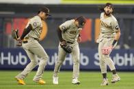 San Diego Padres' Juan Soto, left, and Fernando Tatis Jr., right, celebrate with Trent Grisham, center, after a baseball game against the New York Yankees, Friday, May 26, 2023, in New York. (AP Photo/Frank Franklin II)