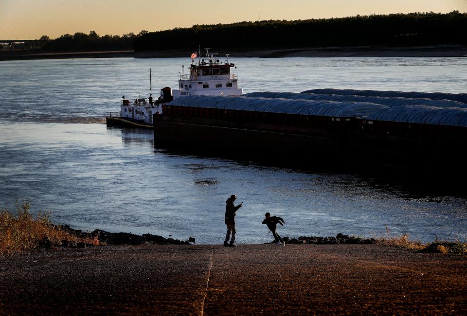 DeSeam Williams, 9, runs around his father Dennis Williams while they check out historically low water levels of the Mississippi River on Oct. 26, 2022 in Greenbelt Park in Memphis. (Mark Weber/The Daily Memphian)