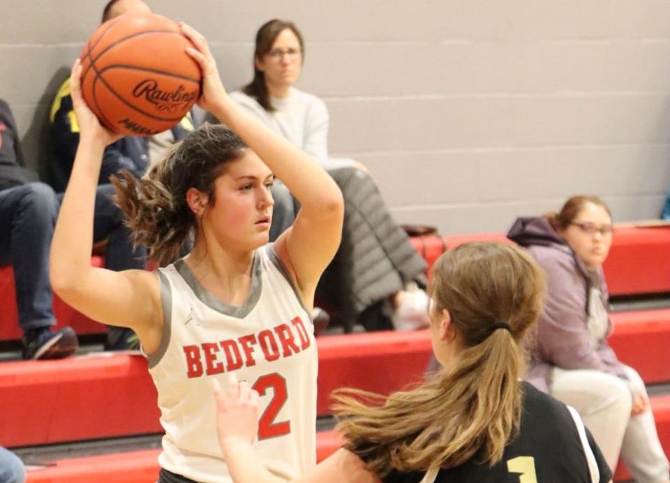 Anna Gray of Bedford looks to pass against Ann Arbor Huron Tuesday night. Gray scored a career-high 15 points to lead the Mules to a 62-32 win.
