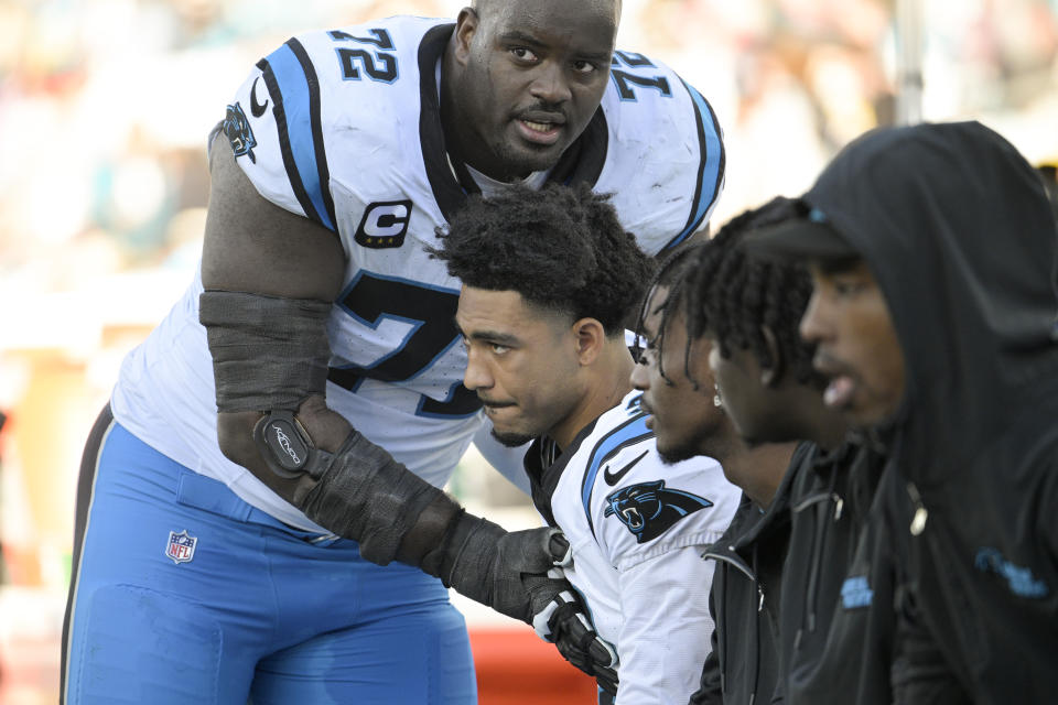 Carolina Panthers offensive tackle Taylor Moton greets quarterback Bryce Young during their loss against the Jacksonville Jaguars in an NFL football game Sunday, Dec. 31, 2023, in Jacksonville, Fla. (AP Photo/Phelan M. Ebenhack)