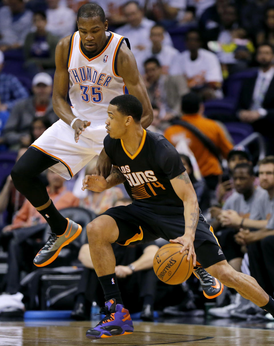 Oklahoma City Thunder forward Kevin Durant (35) jumps as Phoenix Suns' Gerald Green drives during the first half of an NBA basketball game on Thursday, March 6, 2014, in Phoenix. (AP Photo/Matt York)