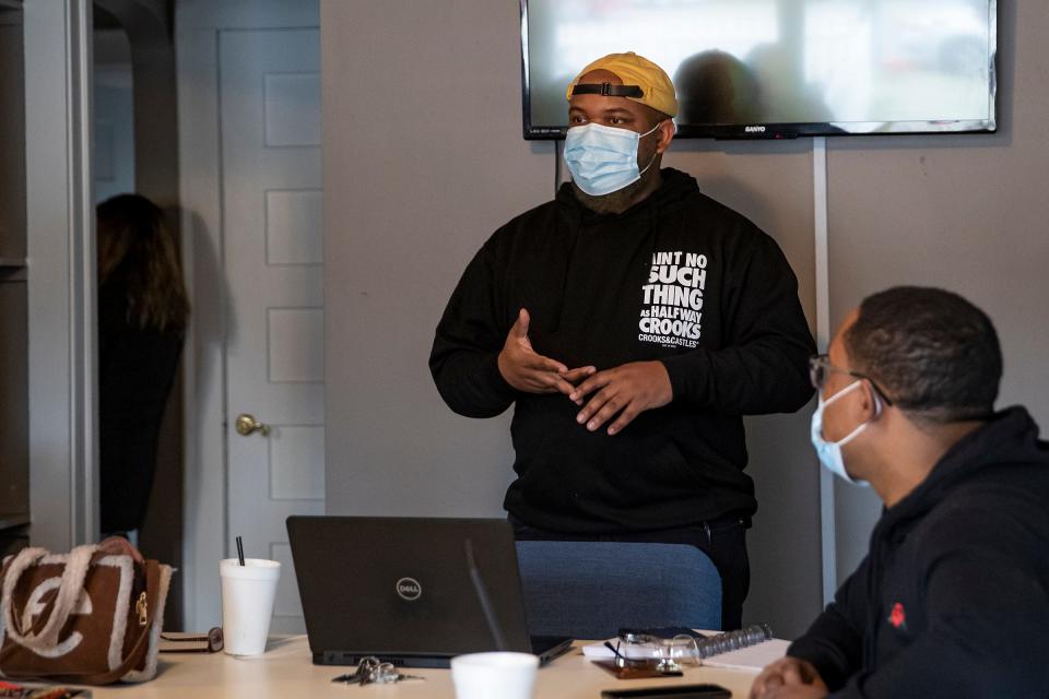 Associate Director Calvin Larkins (right) talks during a staff meeting at Trans Solutions Research and Resource Center on Tuesday, Feb. 22, 2022, in Indianapolis. 