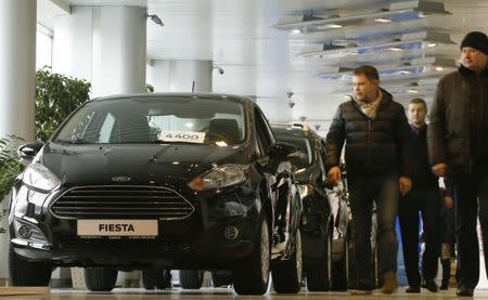 Visitors walk past Ford cars at a dealership of Genser company in Moscow, Russia, February 14, 2017. REUTERS/Maxim Shemetov