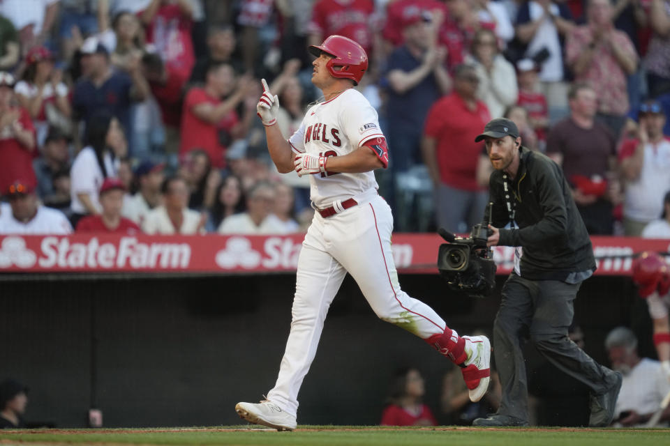 Los Angeles Angels' Hunter Renfroe (12) celebrates as he runs the bases after hitting a home run during the fourth inning of a baseball game against the Kansas City Royals in Anaheim, Calif., Saturday, April 22, 2023. (AP Photo/Ashley Landis)