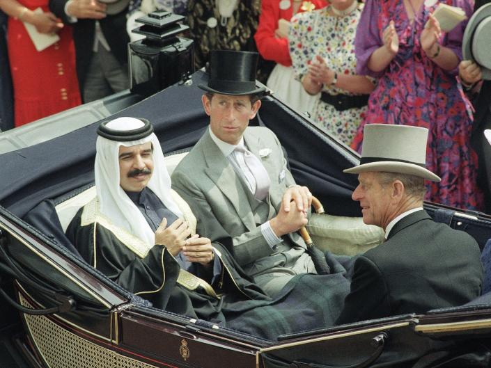 Crown Prince Shaikh Hamed Bin Isa Al-Khalifa of Bahrain, left, rides down the course at Royal Ascot, England on June 22, 1989, accompanied by Britain’s Prince Charles, Prince of Wales, center, and his father the Duke of Edinburgh, Prince Phillip, prior to the start of racing on what is traditionally know as ‘Ladies Day’ at Ascot.