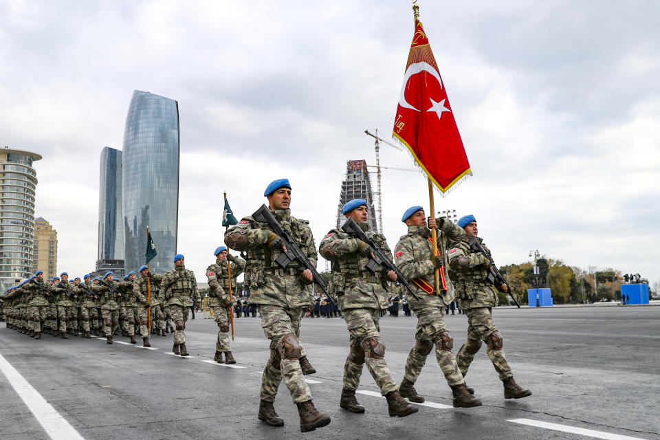 Members of a Turkish forces commando brigade take part in a military parade in which Turkey's President Recep Tayyip Erdogan and Azerbaijan's President Ilham Aliyev, looked on in Baku, Azerbaijan, Thursday, Dec. 10, 2020. The massive parade was held in celebration of the peace deal with Armenia over Nagorno-Karabakh that saw Azerbaijan reclaim much of the separatist region along with surrounding areas. (AP Photo)