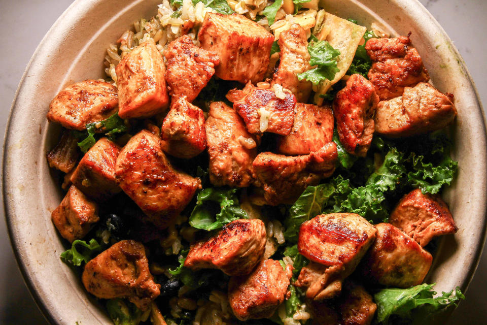 The Apollo at Roots Natural Kitchen, made with chicken, spinach, chickpeas, grape tomatoes, red onion, cucumbers, pita chips and feta cheese over brown rice.