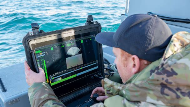 PHOTO: A Sailor assigned to Explosive Ordnance Disposal Group 2 conducts a search for debris with an underwater vehicle during recovery efforts of a high-altitude balloon in the Atlantic Ocean, Feb. 7, 2023. (Mass Communication Specialist 1st Class Ryan Seelbach/U.S. Navy)