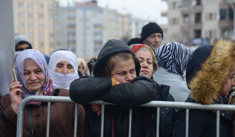 Unas mujeres observan al personal de rescate mientras busca víctimas y supervivientes entre los escombros de los edificios de Kahramanmaras, Turquía, el día después de que un terremoto de magnitud 7,8 sacudiera el sureste del país, el 7 de febrero de 2023.