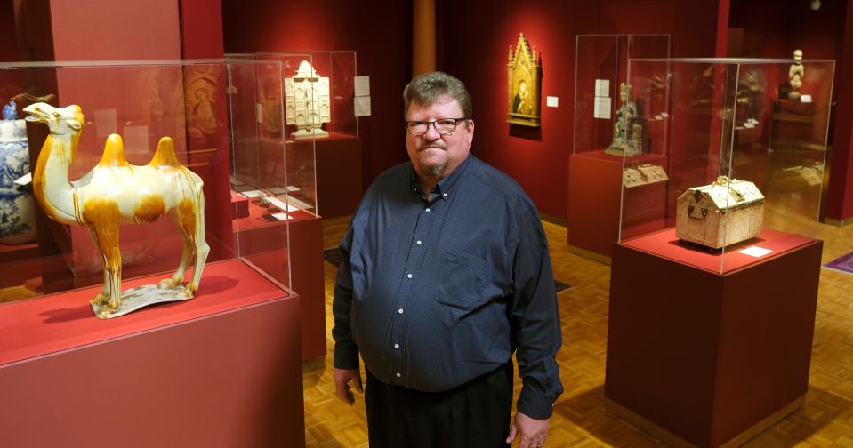 Dane Pollei, director and chief curator of the Mabee-Gerrer Museum of Art, poses next to a terra cotta camel dating back to China's Tang Dynasty March 1, 2022, in Shawnee.