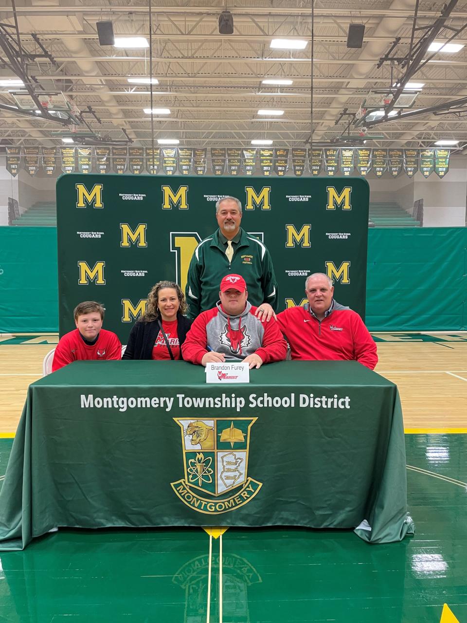 Montgomery's Brandon Furey signs his National Letter of Intent to play football at Marist College on Wednesday, Nov. 10, 2021.