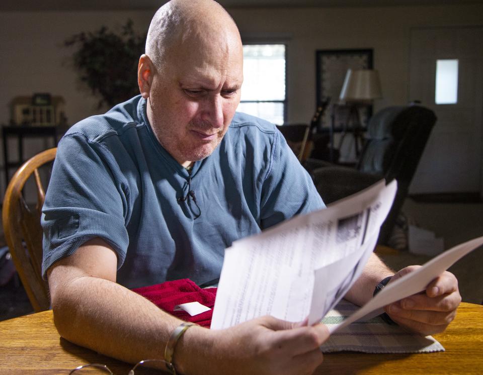 Jim Boerner, a U.S. Air Force veteran, may lose his Mesa home over $236 in unpaid taxes he thought had been paid. He looks at real estate documents on July 8, 2019.