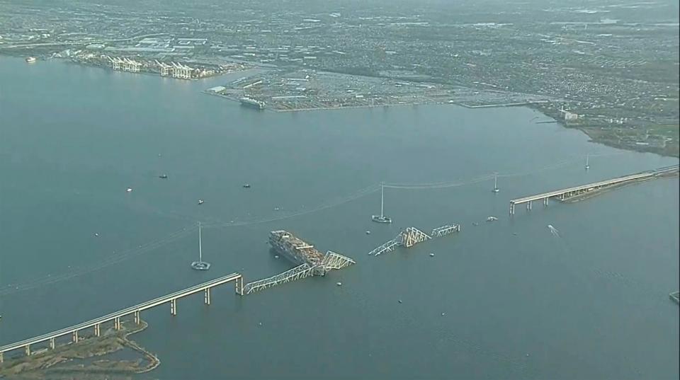 Parts of the Francis Scott Key Bridge remain after a container ship collided with a support Tuesday, March 26, 2024 in Baltimore. The major bridge in Baltimore snapped and collapsed after a container ship rammed into it early Tuesday, and several vehicles fell into the river below. Rescuers were searching for multiple people in the water. (WJLA via AP)