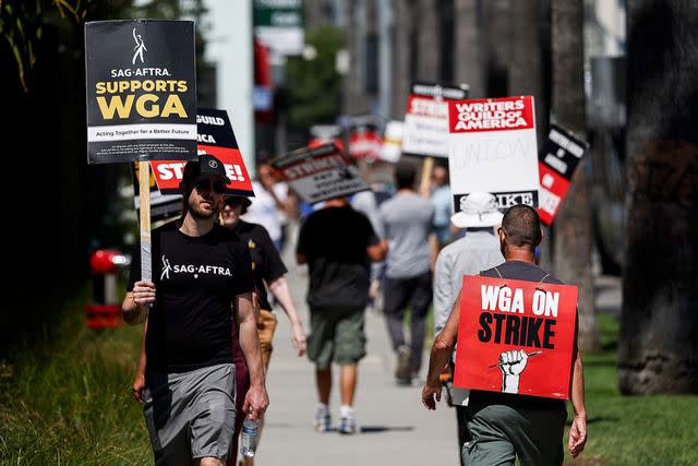 <p>Mario Tama/Getty </p> SAG-AFTRA strike participants on July 11, 2023, in Los Angeles