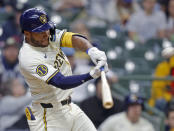 Milwaukee Brewers' Jackson Chourio hits a home run during the fifth inning of a baseball game against the Minnesota Twins, Wednesday, April 3, 2024, in Milwaukee. It was his first major league home run. (AP Photo/Jeffrey Phelps)