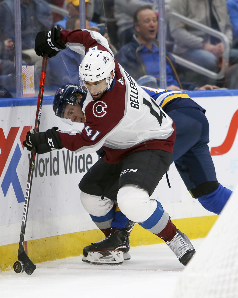 Colorado Avalanche's Pierre-Edouard Bellemare (41), of France, handles the puck in front of St. Louis Blues' Robert Thomas (18) during the second period of an NHL hockey game Monday, Oct. 21, 2019, in St. Louis. (AP Photo/Scott Kane)