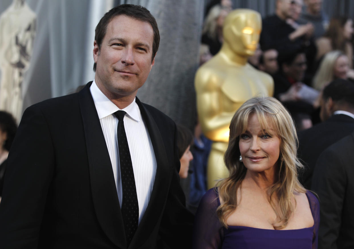 John Corbett and Bo Derek arrive before the 84th Academy Awards on Sunday, Feb. 26, 2012, in the Hollywood section of Los Angeles. (AP Photo/Matt Sayles)