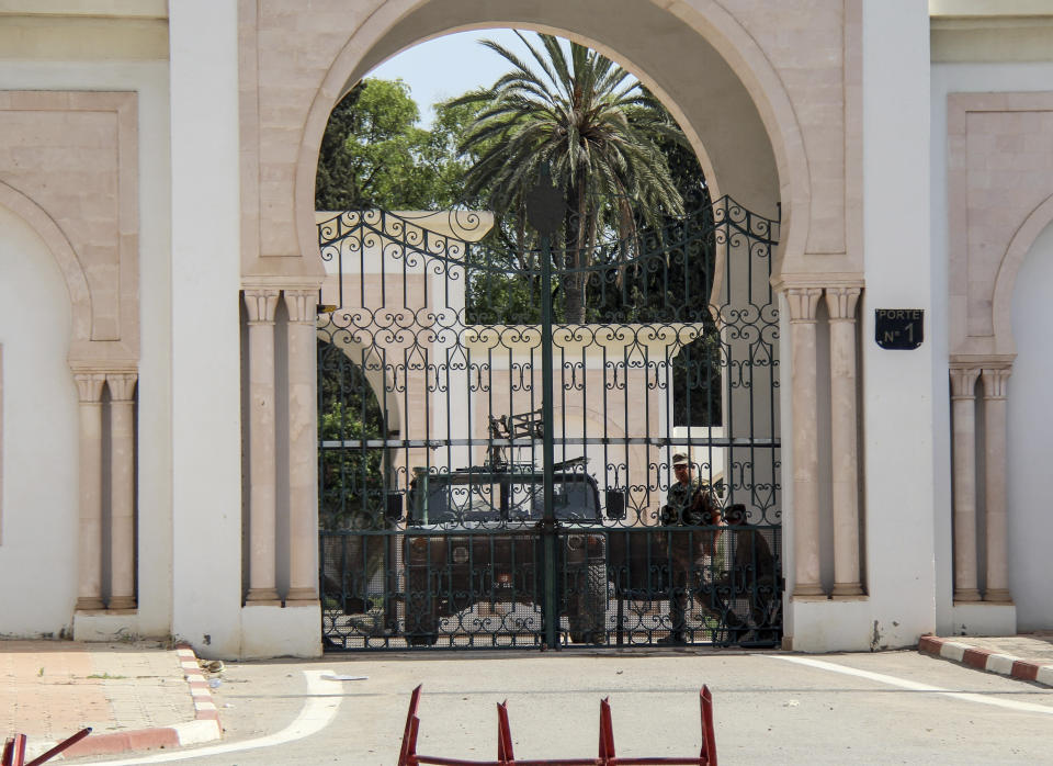 Tunisian soldiers guard an entrance of the parliament in Tunis, Tunisia, Monday, July 26, 2021. Troops surrounded Tunisia's parliament and blocked its speaker from entering Monday after the president suspended the legislature and fired the prime minister following nationwide protests over the country's economic troubles and the government's handling of the coronavirus crisis. (AP Photo/Hedi Azouz)