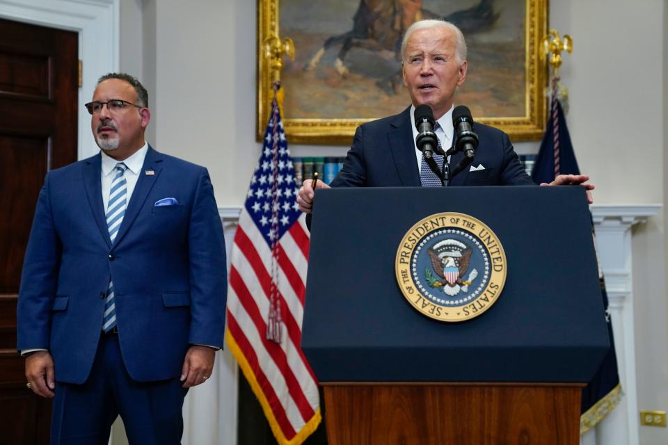 President Joe Biden speaks in the Roosevelt Room of the White House,  June 30, 2023, in Washington, as his administration is moving forward on a new student debt relief plan after the Supreme Court struck down his original initiative. Education Secretary Miguel Cardona listens at left. Two conservative groups are asking a federal court to block the Biden administration’s plan to cancel $39 billion in student loans for more than 800,000 borrowers.