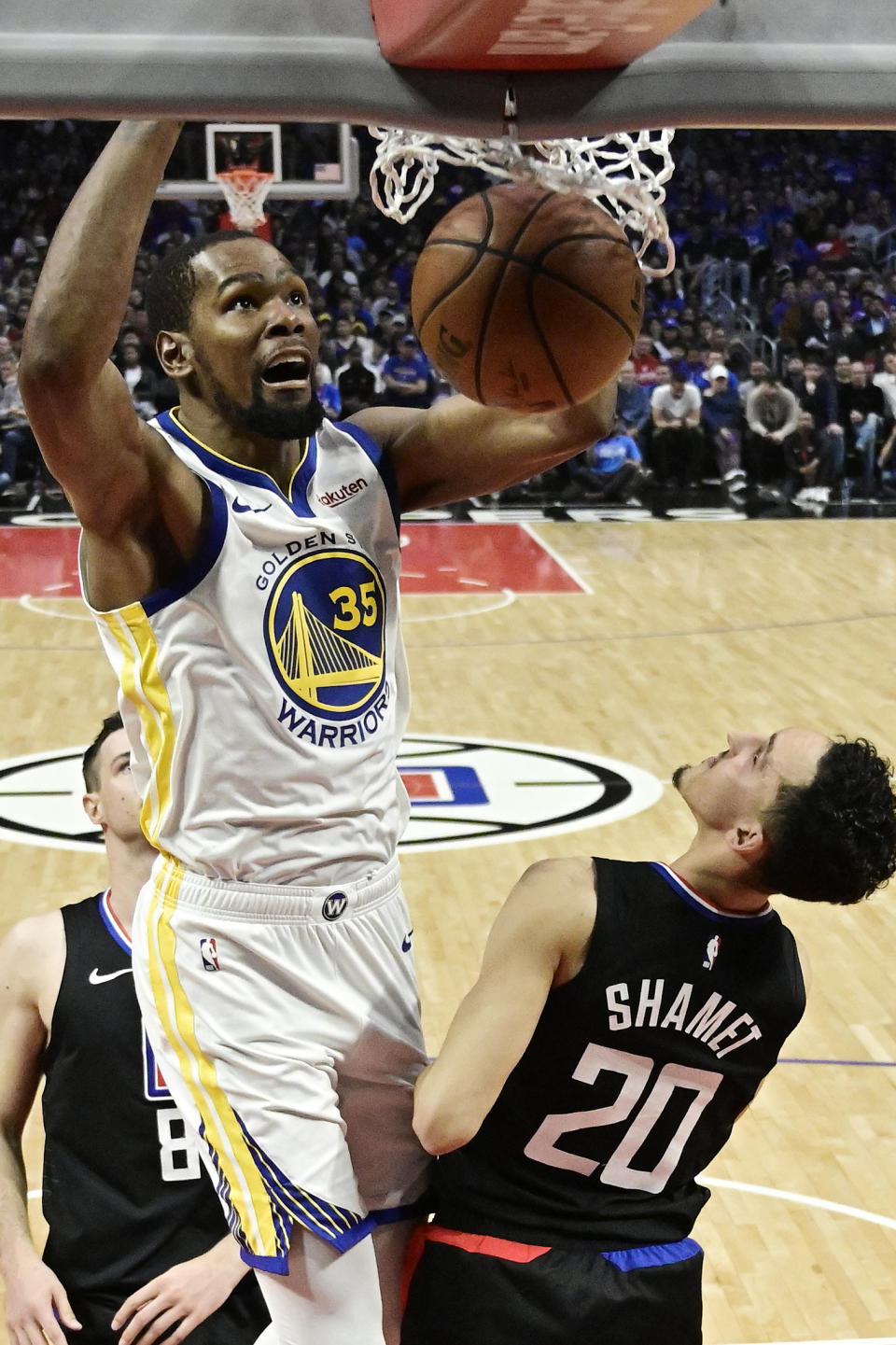 FILE - In this April 21, 2019, file photo, Golden State Warriors forward Kevin Durant, top, dunks as Los Angeles Clippers guard Landry Shamet defends during the second half in Game 4 of a first-round NBA basketball playoff series in Los Angeles. Rarely relevant at the same time on the basketball court, the Knicks and Nets are front and center in the free agency race, two of the teams best positioned to make a splash when the market opens. Both can afford two top players, with hopes of landing not only a Kevin Durant or Kyrie Irving, but possibly even both. (AP Photo/Mark J. Terrill, File)