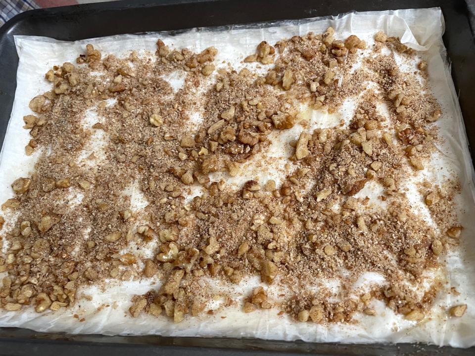 Adding walnuts to phyllo for Anneta's dad's baklava