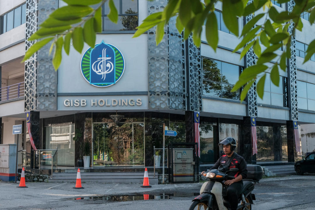 A man rides by the Global Ikhwan Service and Business Holdings (GISBH) headquarters building at Rawang. (PHOTO: Faris Hadziq/SOPA Images/LightRocket via Getty Images)