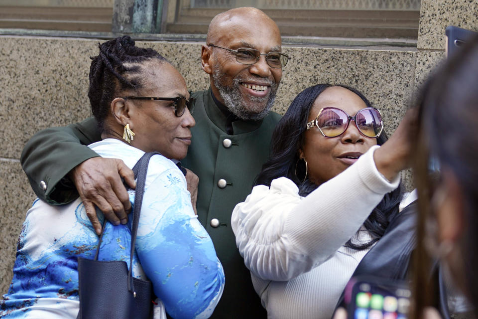 FILE - Muhammad Aziz stands outside the courthouse with members of his family after his conviction in the killing of Malcolm X was vacated on Nov. 18, 2021, in New York. Aziz, 84, has filed a $40 million lawsuit against New York City for the two decades he spent in prison for a notorious crime he did not commit. (AP Photo/Seth Wenig, File)