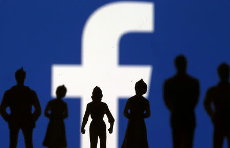 FILE PHOTO: Small toy figures are seen in front of Facebook logo in this illustration picture, April 8, 2019. REUTERS/Dado Ruvic/File Photo