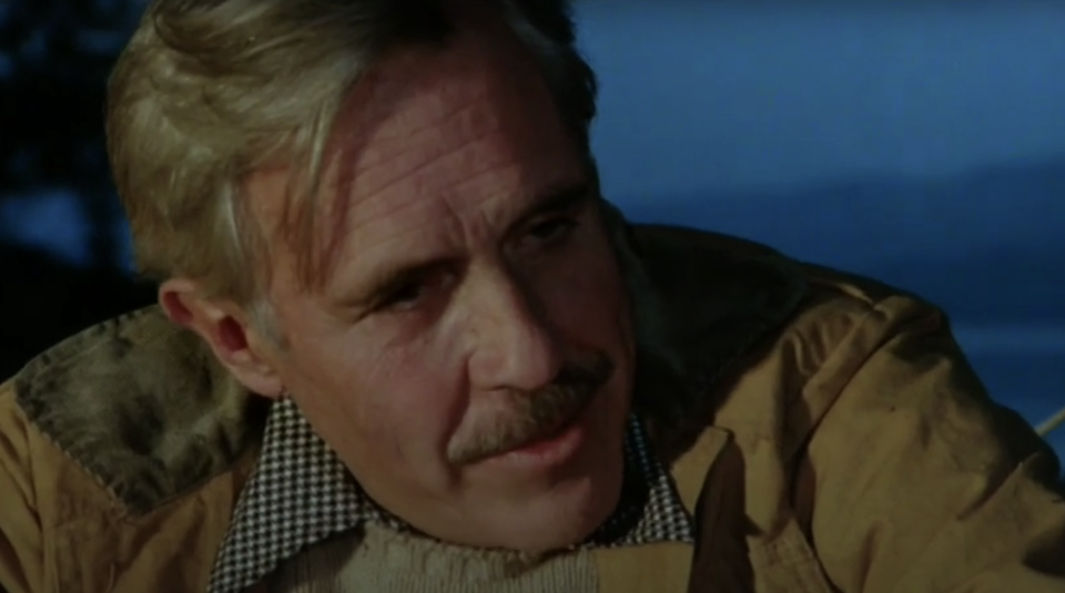 Jason Robards in "Julia" sitting at the beach with a fire going