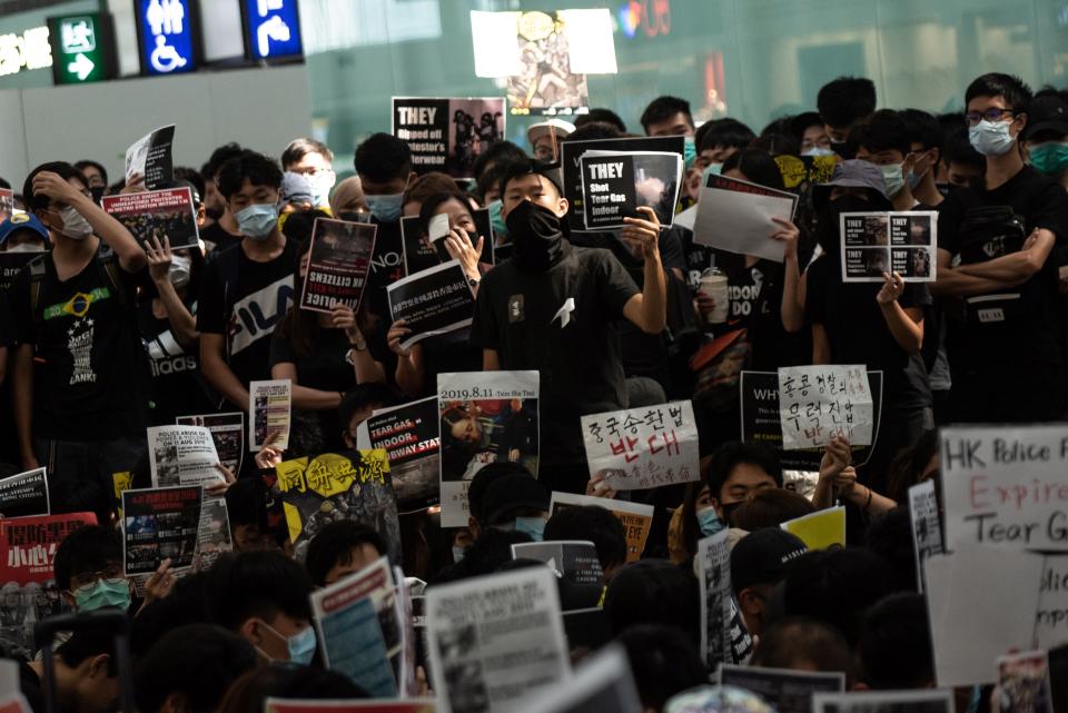 A group of pro-democracy protesters chant slogans outside the departures hall during another demonstration at Hong Kong's international airport on August 13, 2019. (Photo: Philip Fong/NurPhoto via Getty Images)