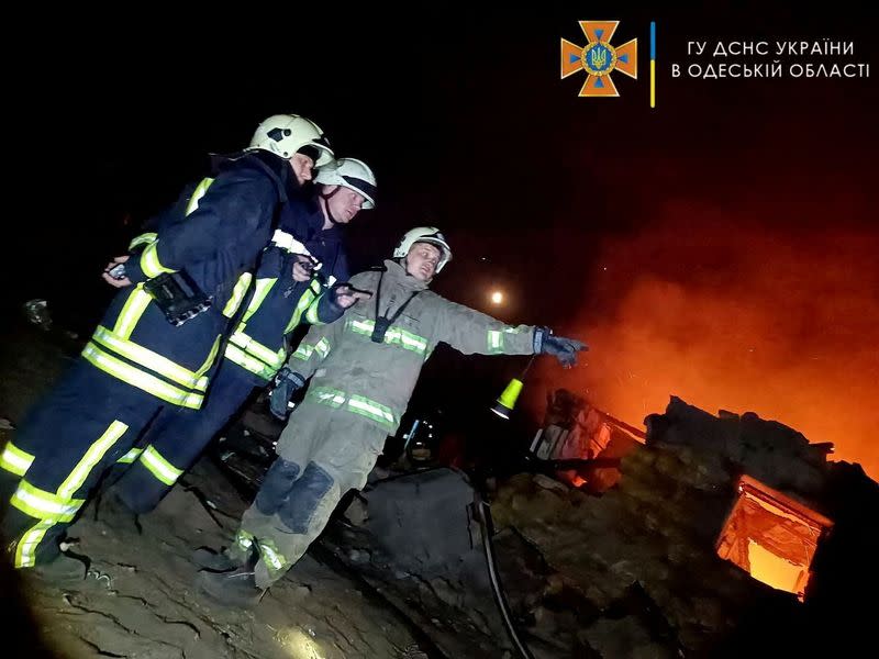 Firefighters work at a scene after a shelling in a location given as Odesa