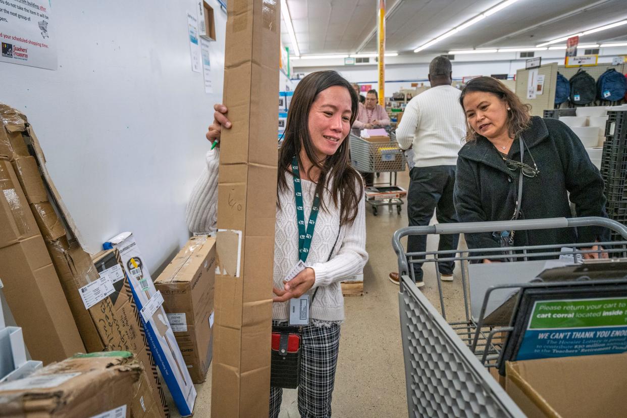 Angelita Peck, left, and Rizalina Goley, from Arsenal Tech High School, join other educators looking for items at Teachers’ Treasures, Monday, Nov. 13, 2023. Marion County teachers of students in need can get free school supplies at the charity store which takes donations.