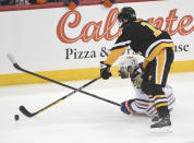 Pittsburgh Penguins right wing Josh Archibald (15) and Edmonton Oilers defenseman Evan Bouchard (2) go for the puck during the first period of an NHL hockey game, Thursday, Feb. 23, 2023, in Pittsburgh. (AP Photo/Philip G. Pavely)