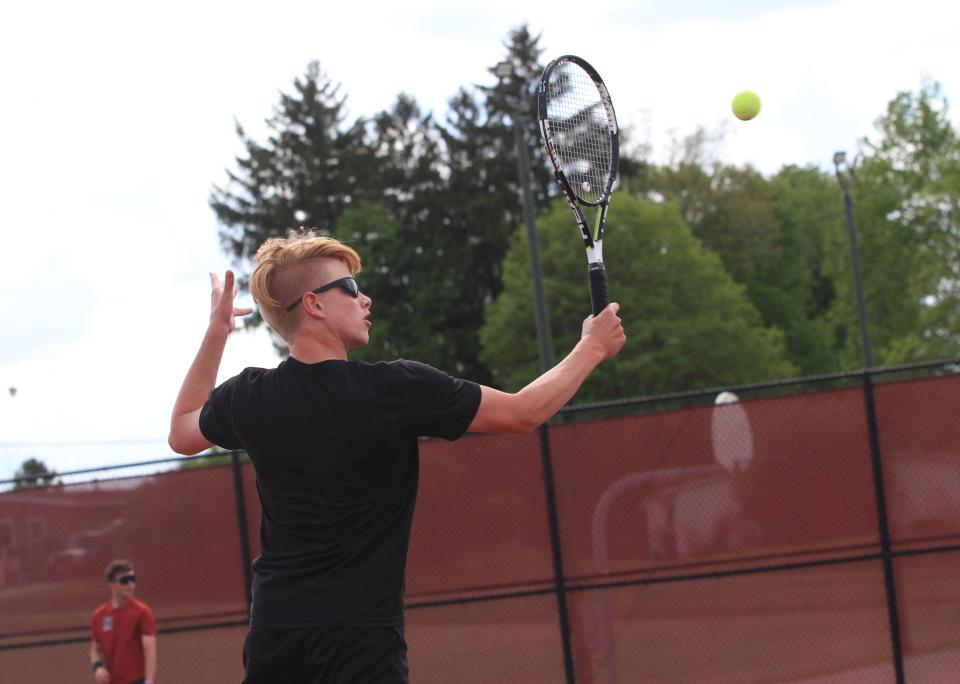 Watkins Memorial's Graham Smith hits a return against Newark on Tuesday.